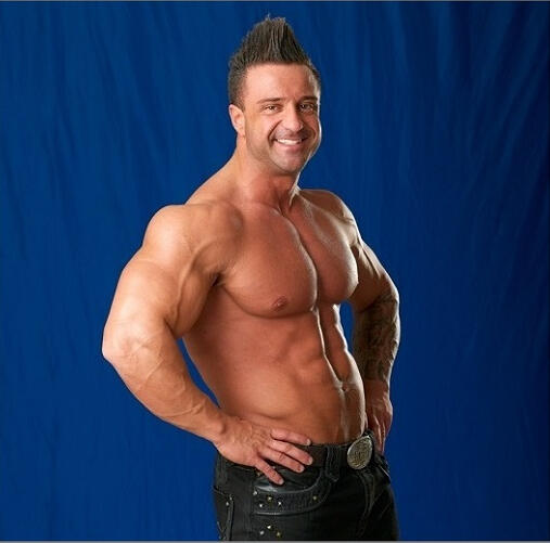 Armani Vegas performer in Canadian Storm Male Revue professional photo smiling with no shirt