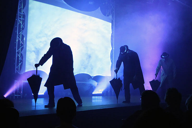Performers in Canadian Storm on stage performing "It's Raining Men" to a sold out crowd