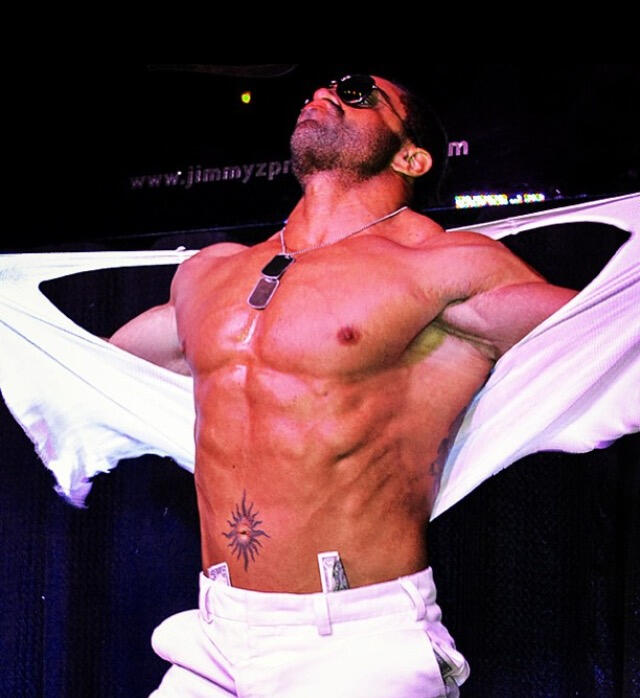 Photo of Armani Vegas of Canadian Storm Male Revue on stage in sunglasses and no shirt