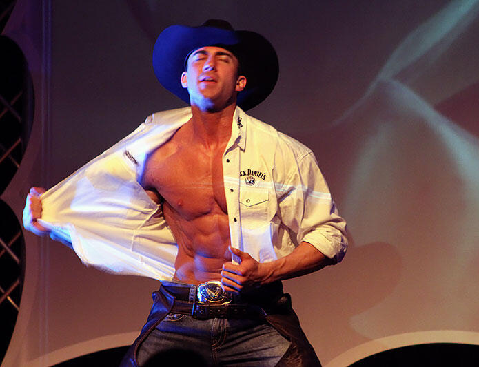 Canadian Storm - Tom Rooney on stage Headline performer Tom Rooney on stage with Canadian Storm Male Revue with shirt unbuttoned as a cowboy