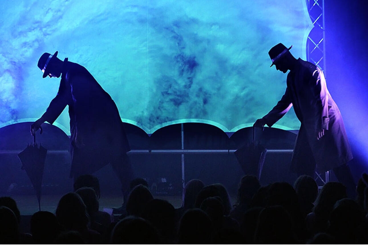 A professional picture of Canadian Storm on stage performing choreography in front of an audience
