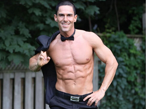 Performer Miguel Storm of Canadian Storm shirtless, professional photo wearing bowtie.